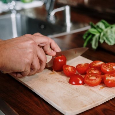 Photo Of Person Slicing Tomatoes